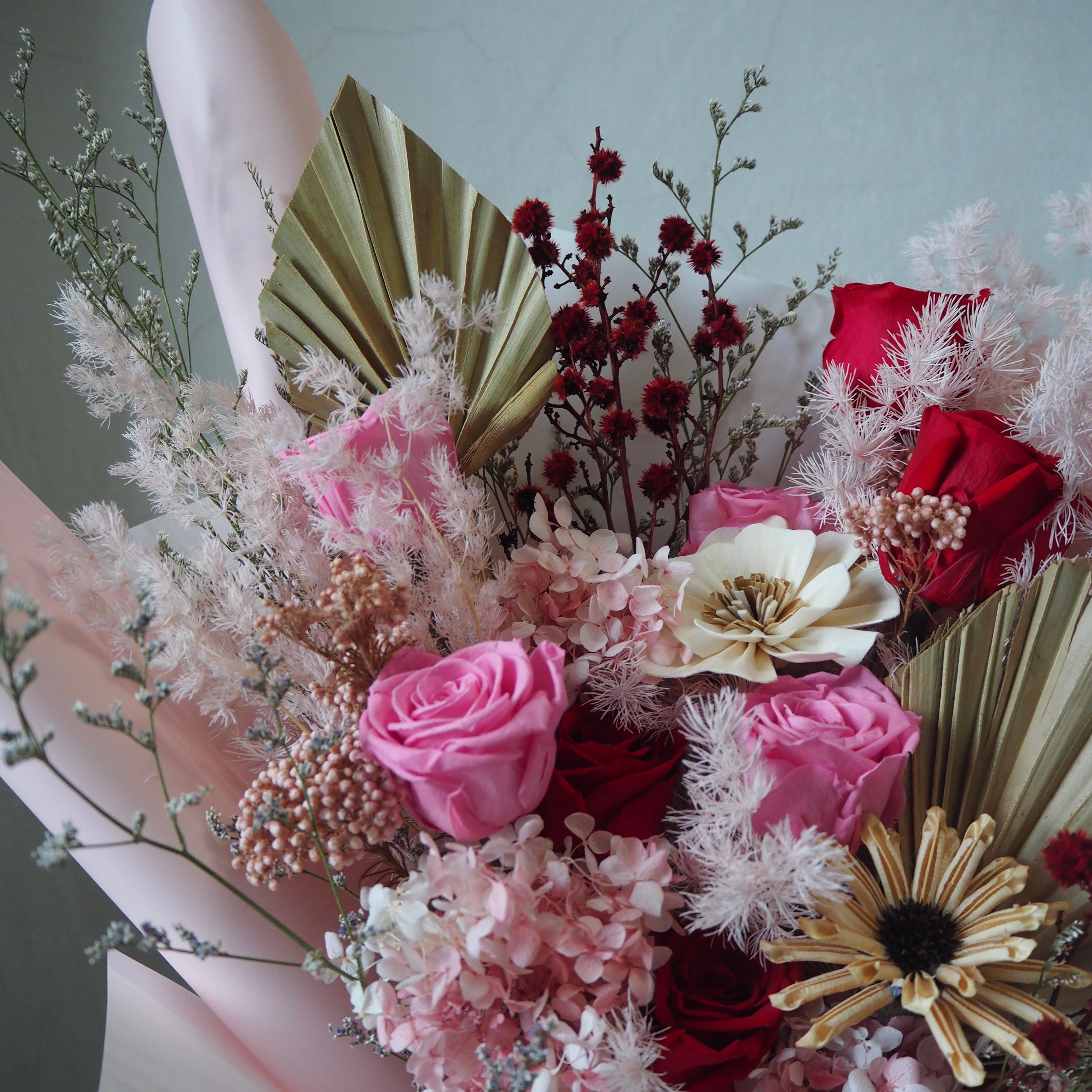 Close up of modern valentine bouquet with pink, red flowers for same day delivery