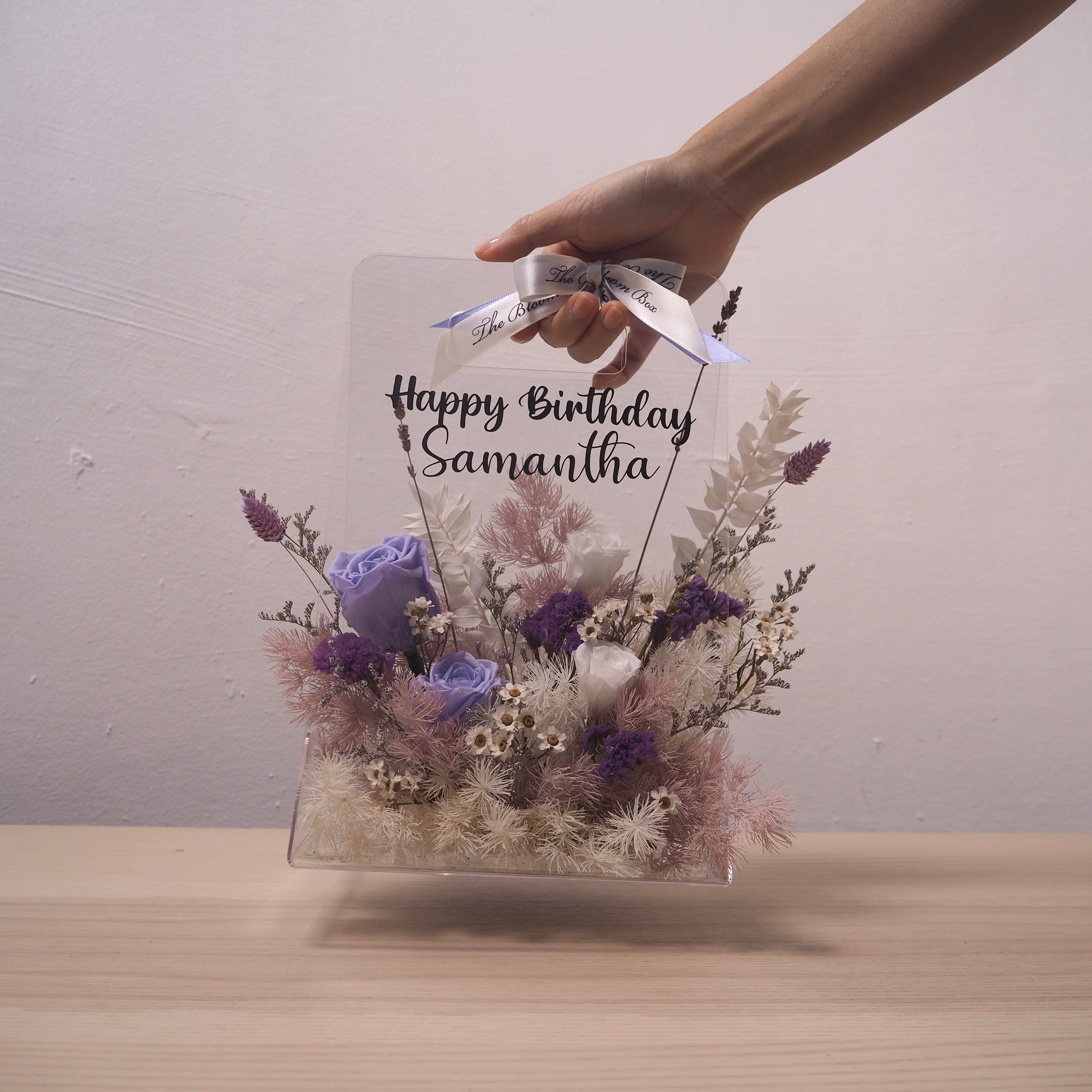 transparent flower box with preserved purple flowers
