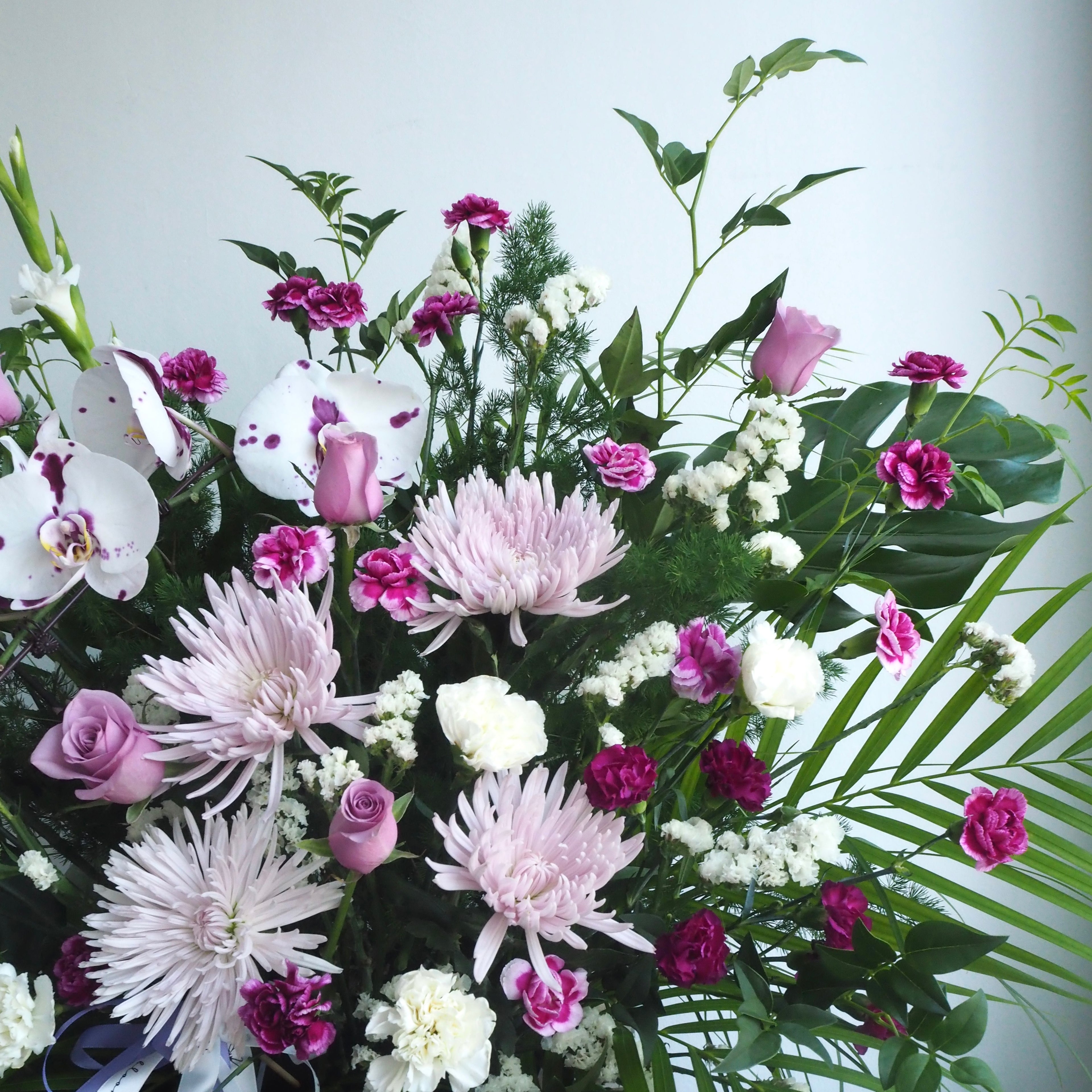 purple orchid funeral flowers close up
