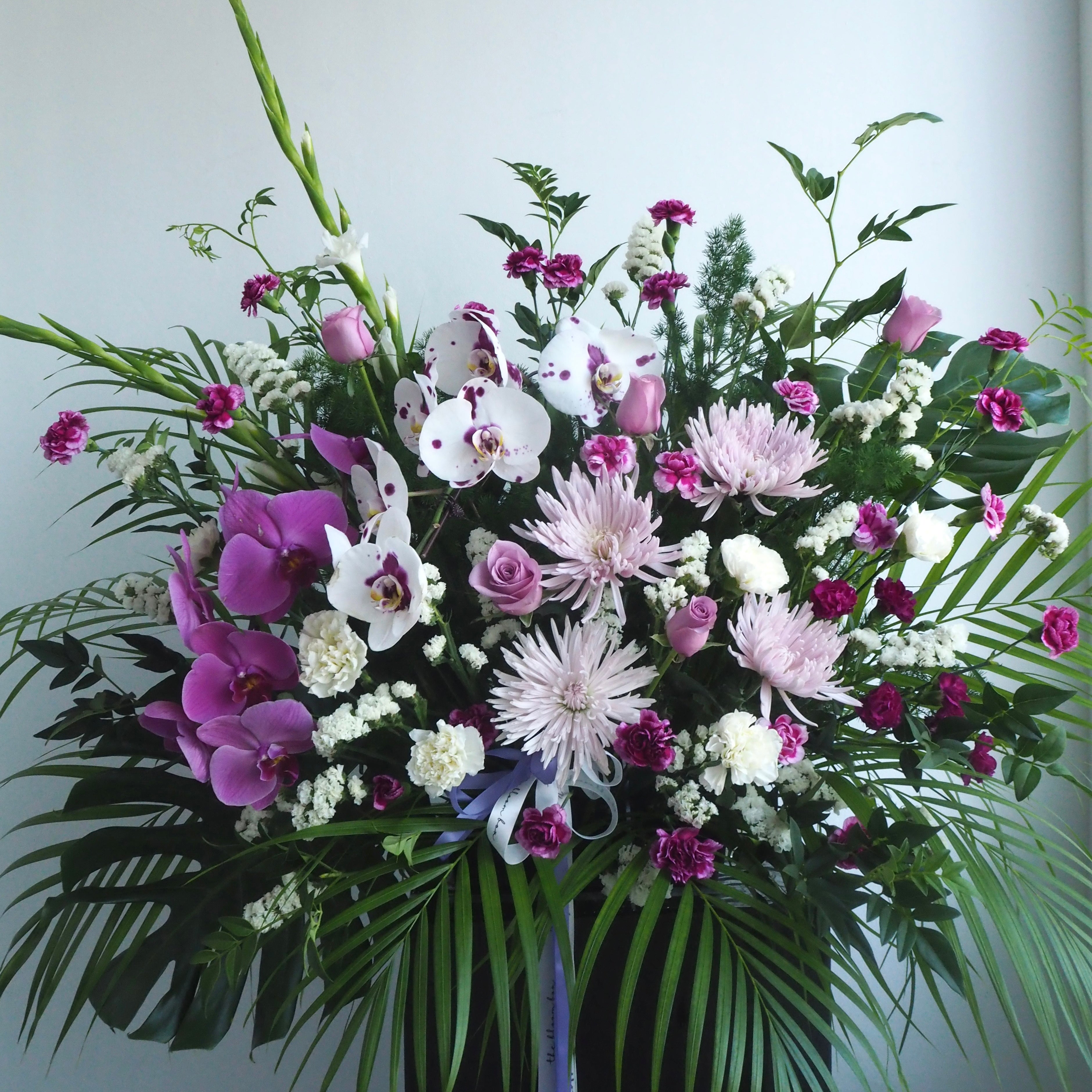 Iris funeral flowers stand positioned at memorial service