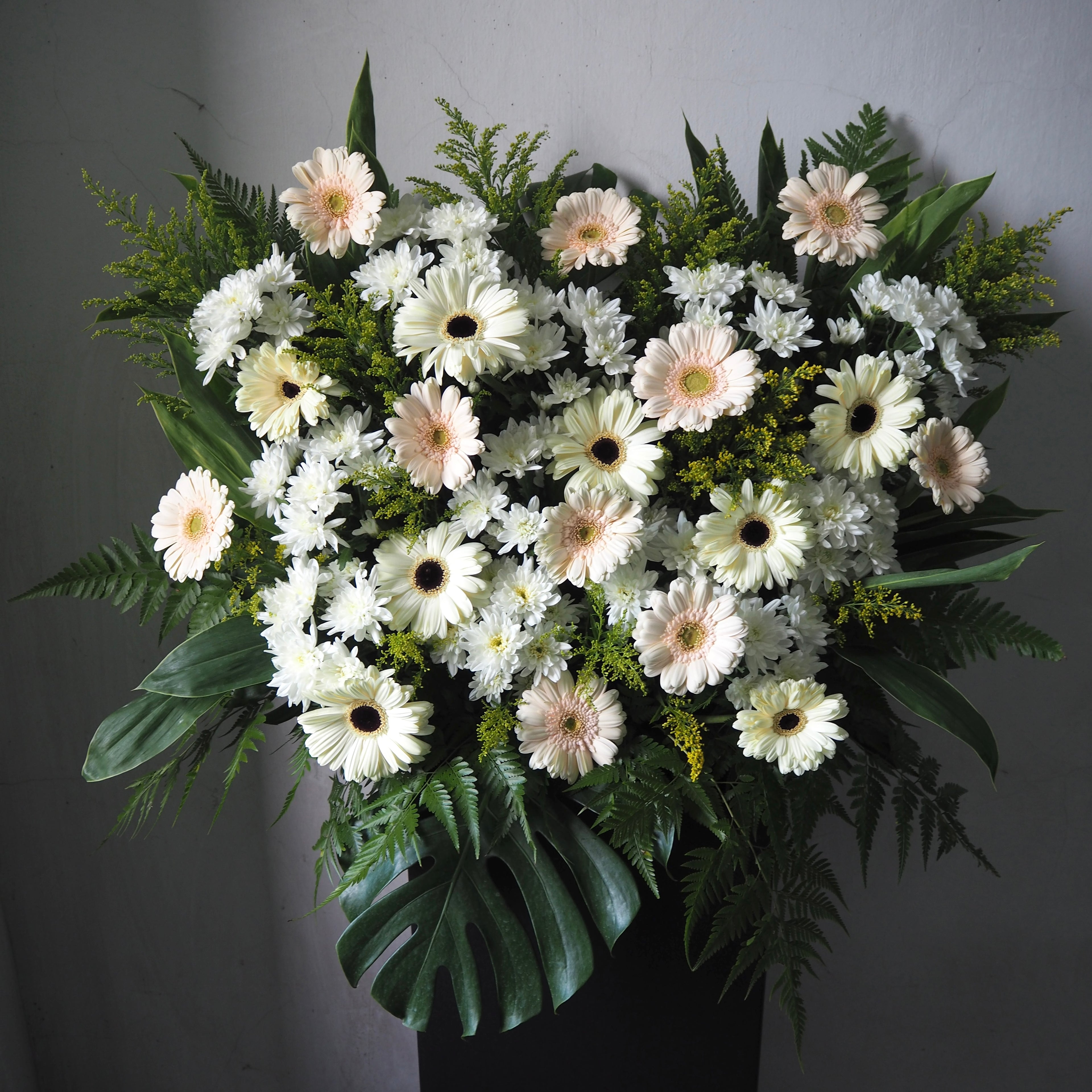 Bouquet of white and green flowers on a gray background