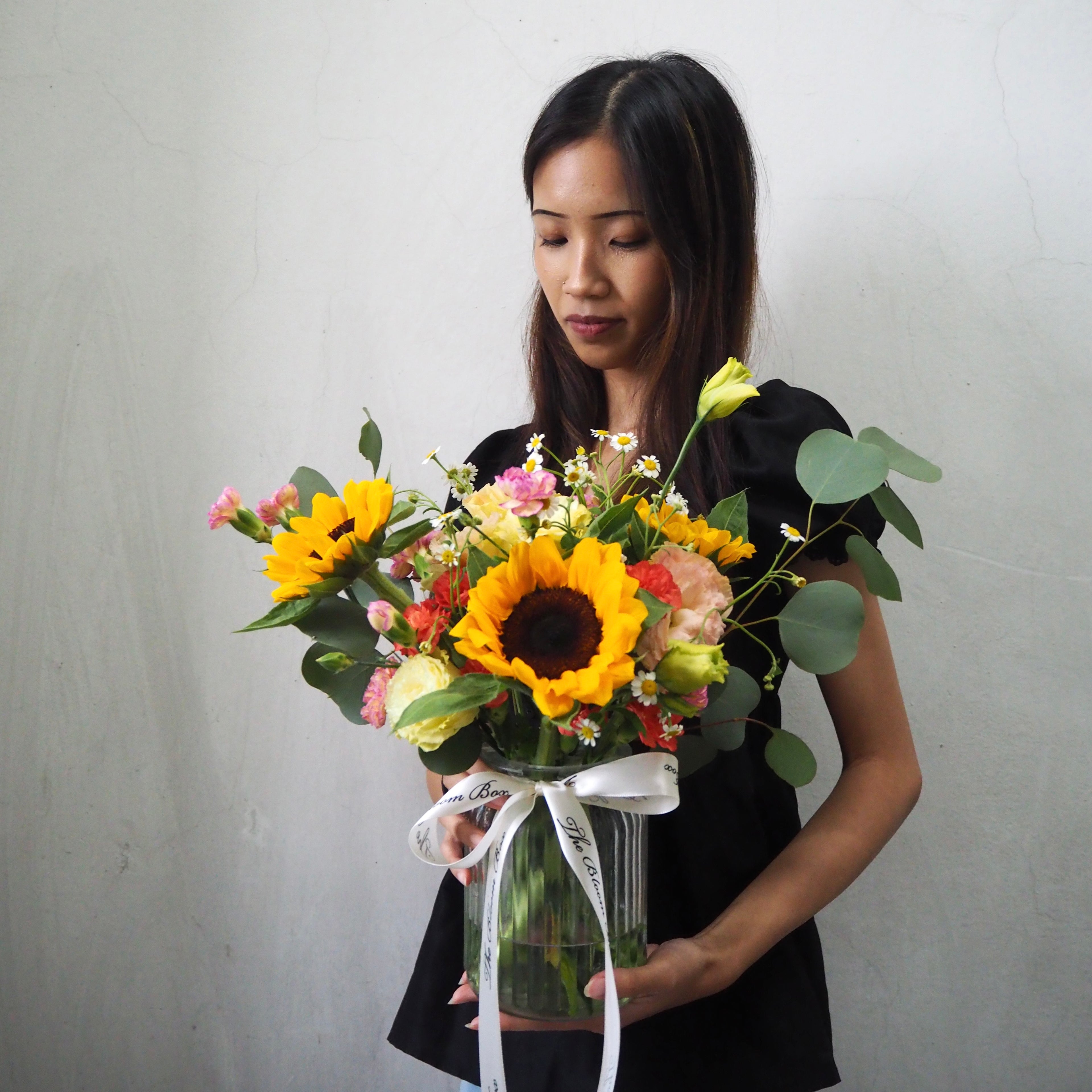 lady with sunflowers arrangement