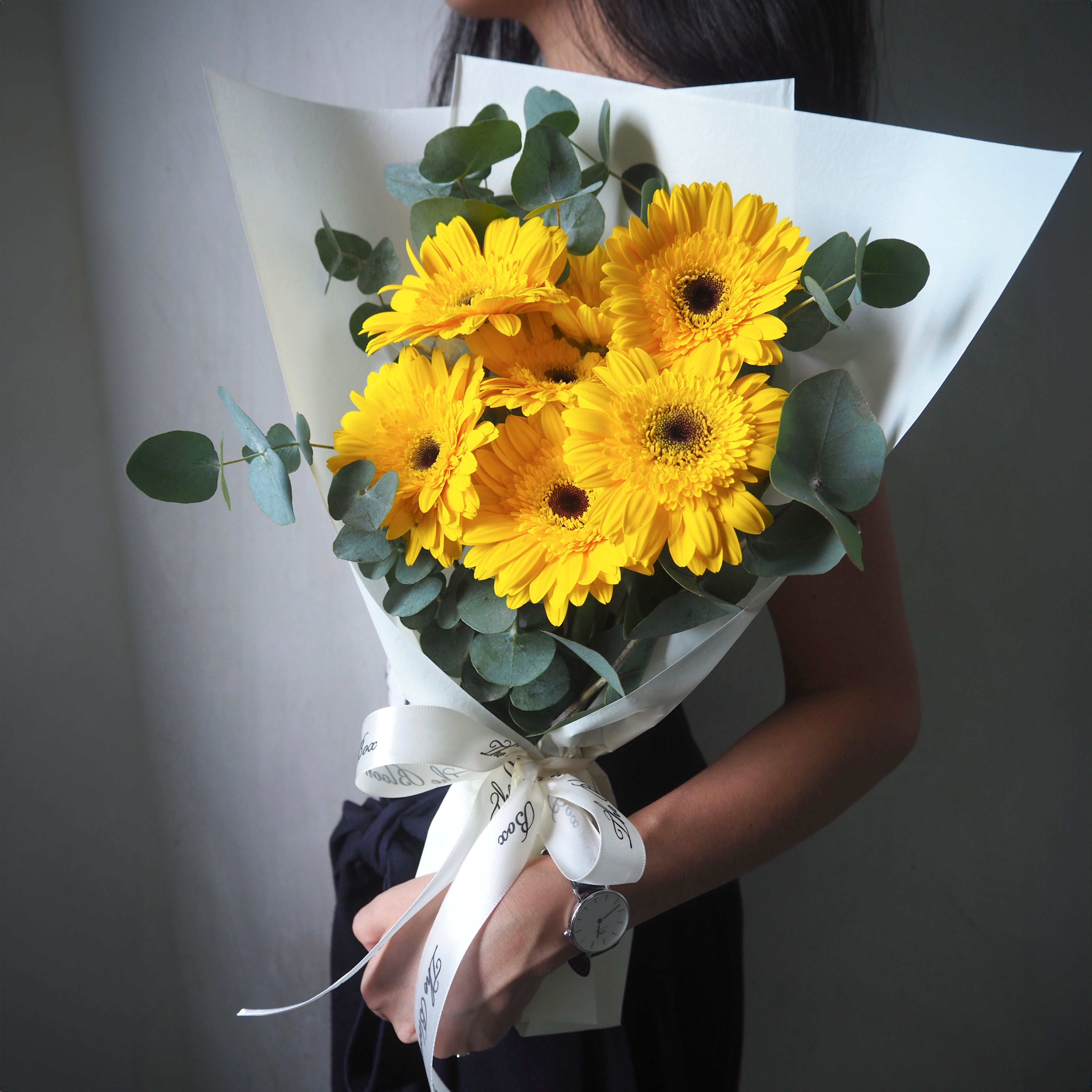 yellow gerbera bouquet hand holding