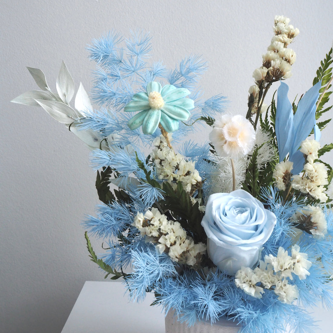 close up of blue preserved flowers vase for birthday celebrations