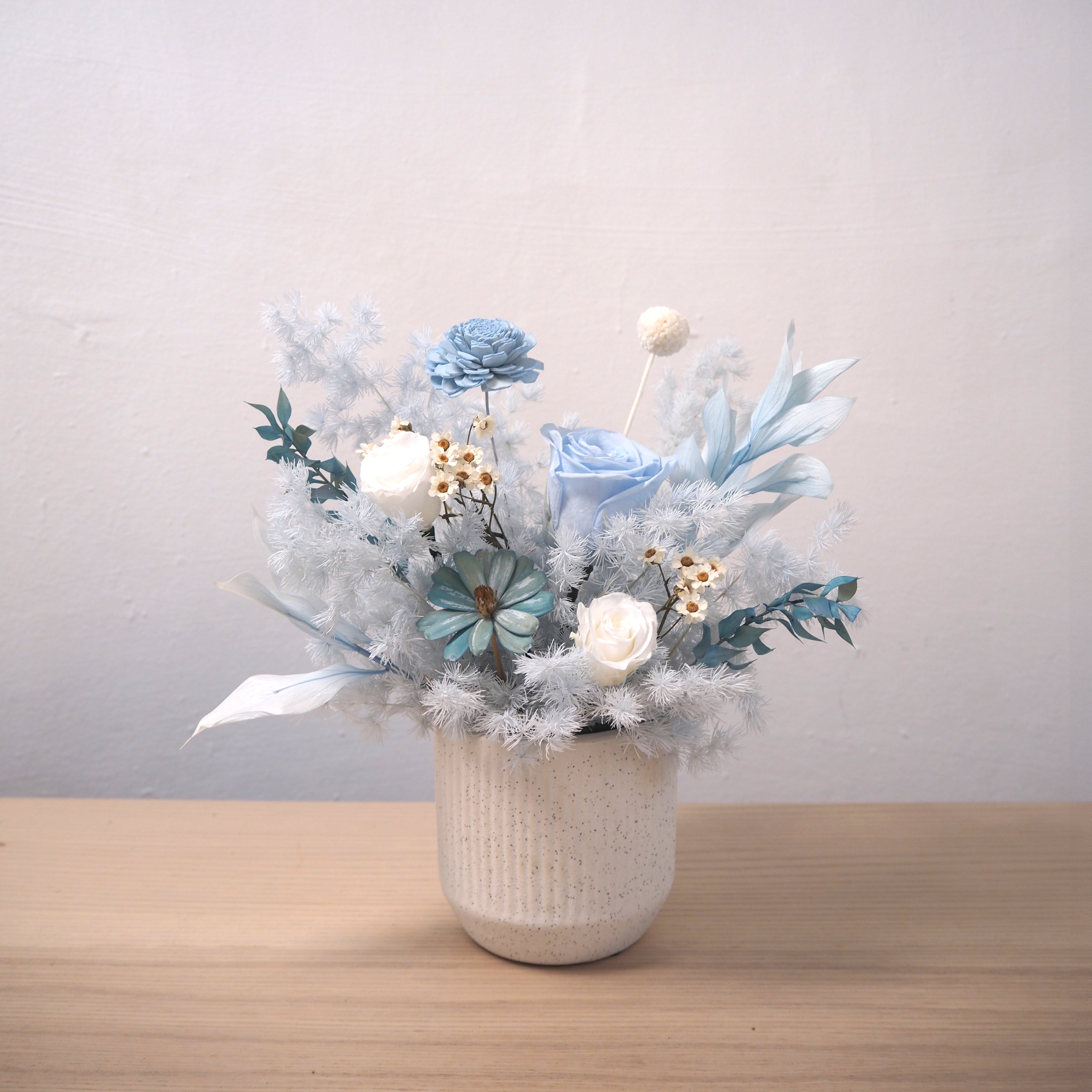 blue flowers arrangement on table