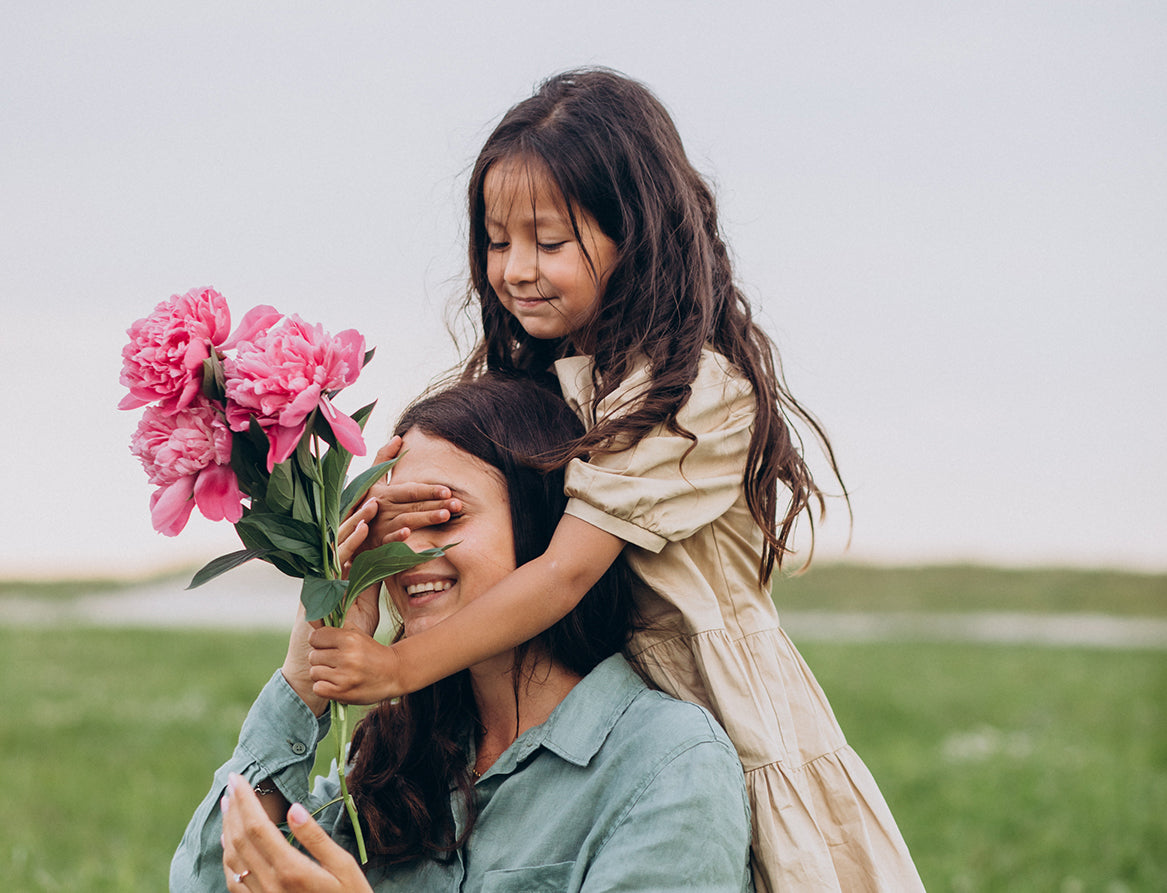 little girl give flowers to mum on mother's day