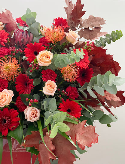 close up side view of congratulations floral stand with red flowers and roses