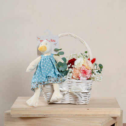 flower arrangement in basket with moulin roty goose soft toy