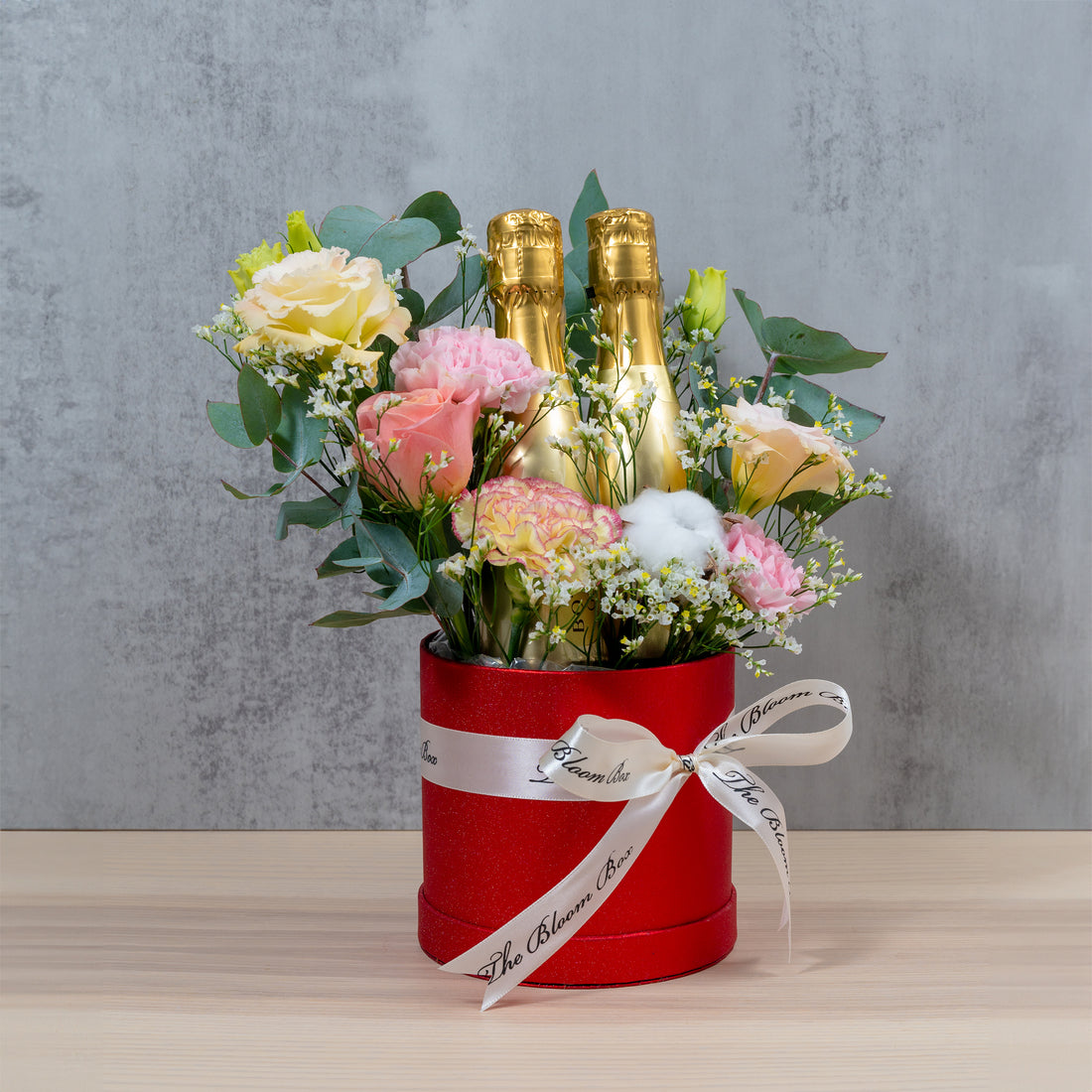 champagne bottles with flower arrangement for congratulations