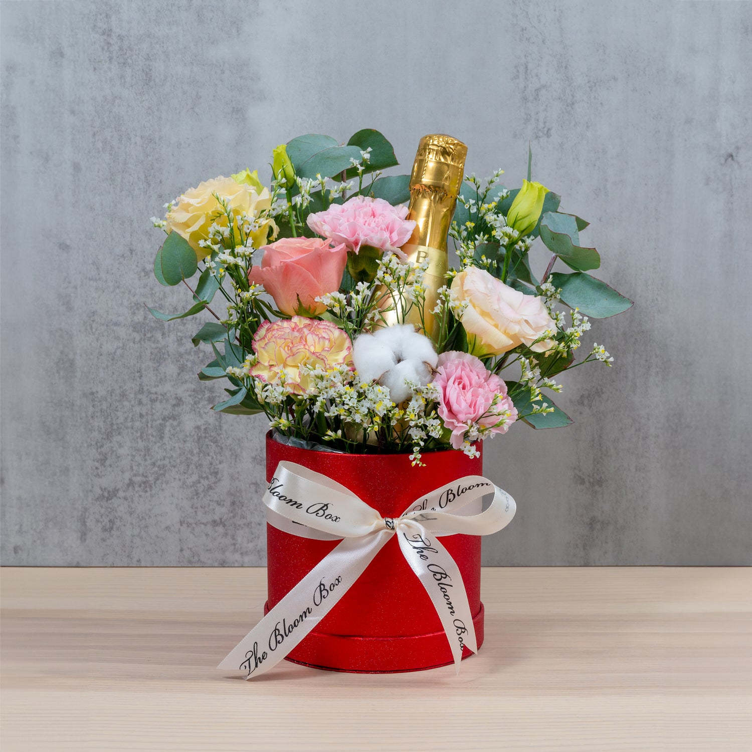 single bottle bottega champagne in flower arrangement 