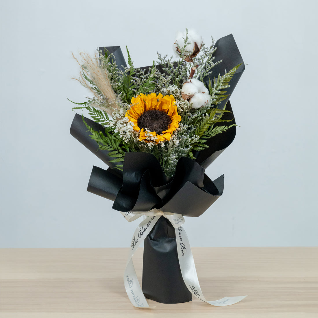 preserved sunflower bouquet wrapped in black paper