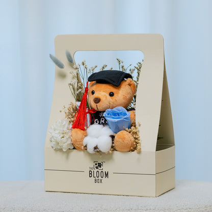 side view of grad bear in blue bloom box