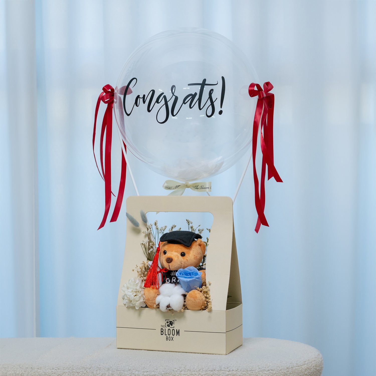 grad bear in blue bloom box with congrats message balloon