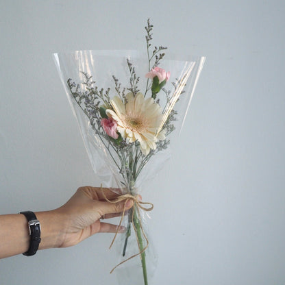 Close-up of colourful gerberas with green fillers, hand-tied Teacher&