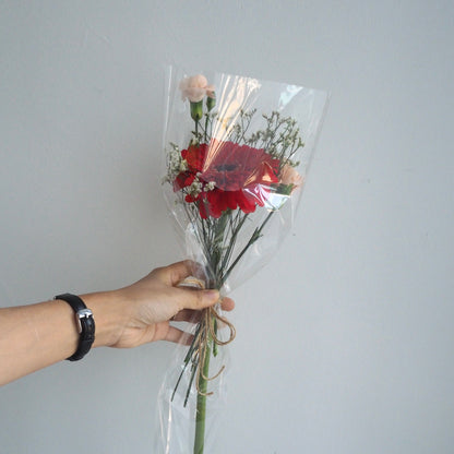 Hand-held gerbera mix bouquet showing random bright colours, ready for same-day delivery