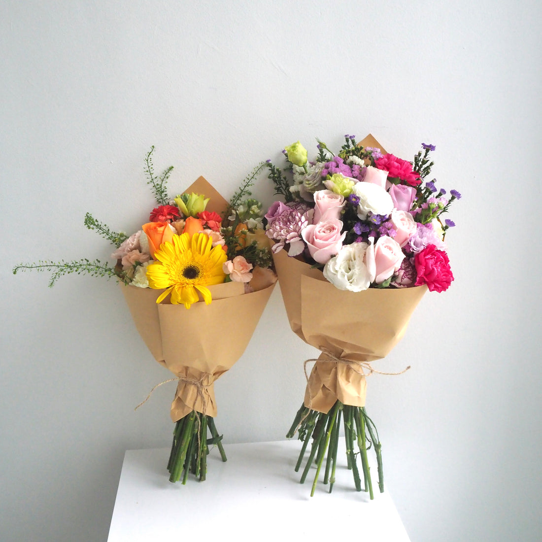 Two fresh flower bouquet side by side