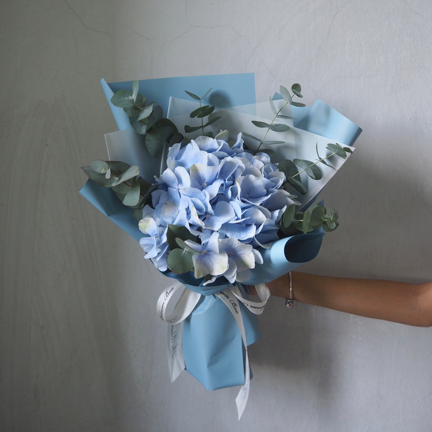 fresh blue hydrangea bouquet wrapped in blue paper