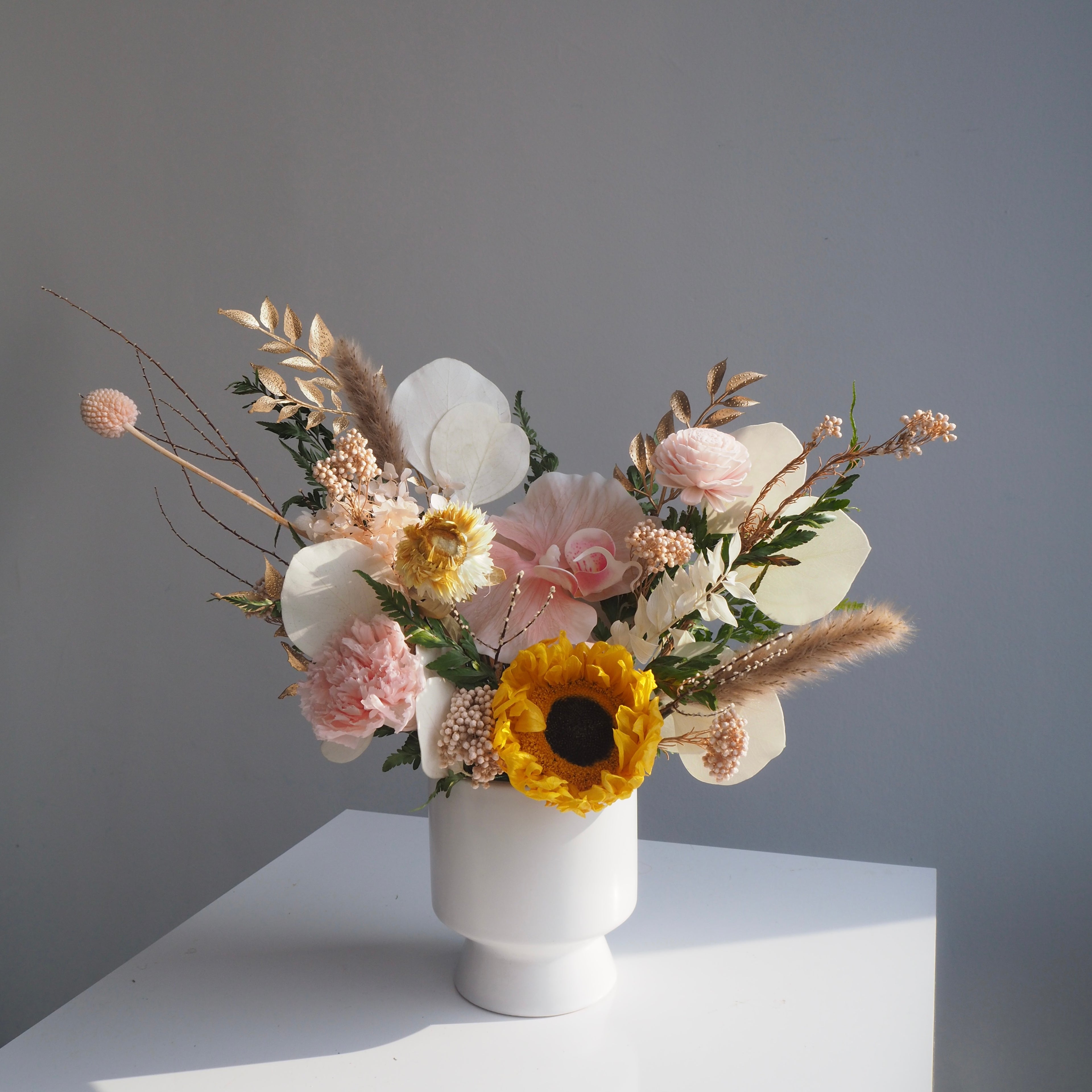 Saffron preserved sunflower vase with pale pink carnations and white blooms, bright cheerful home décor for Singapore