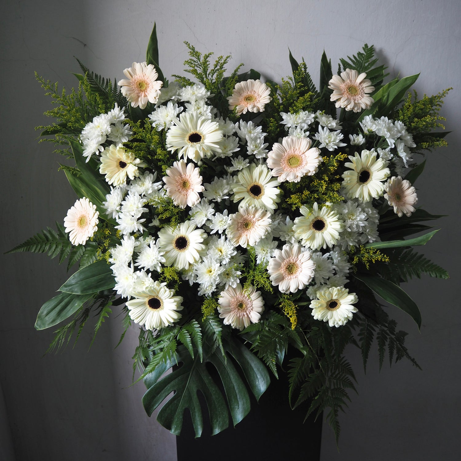 Bouquet of white and green flowers on a gray background