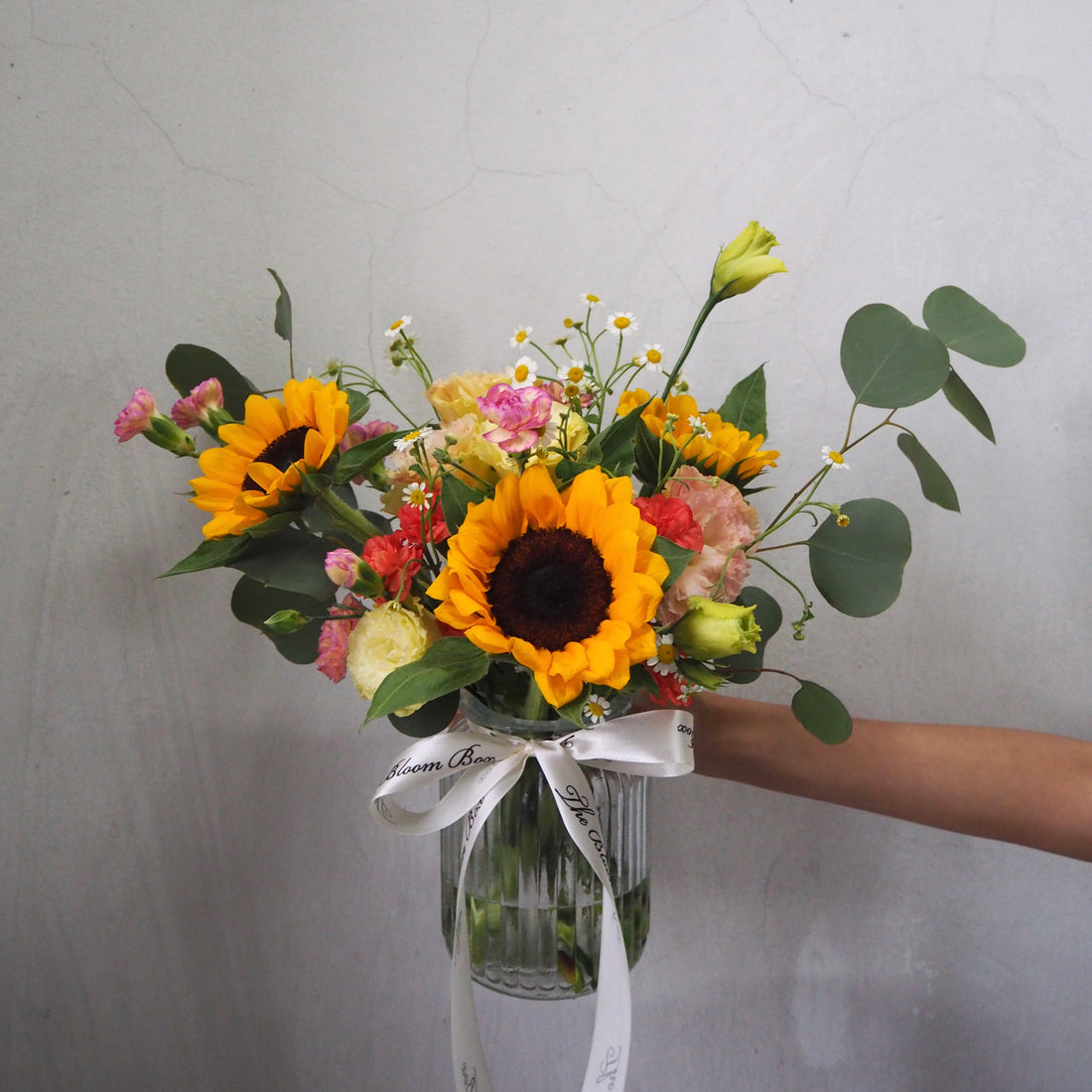 sunflowers arrangement in transparent vase front view