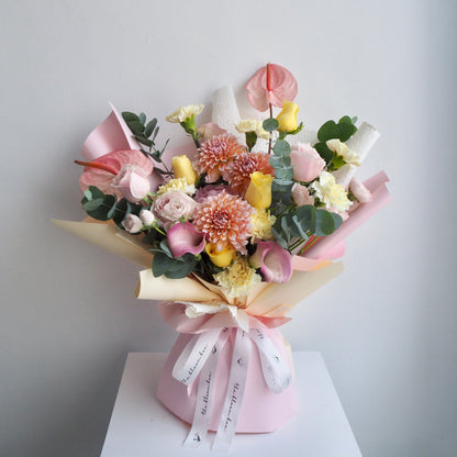 Sorbet luxury fresh flower bouquet with pink calla lilies, dahlias, and roses in soft pink, white, and yellow tones