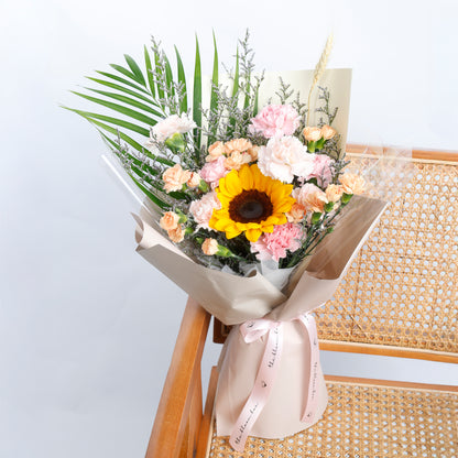 Bouquet of flowers with a sunflower on a light background