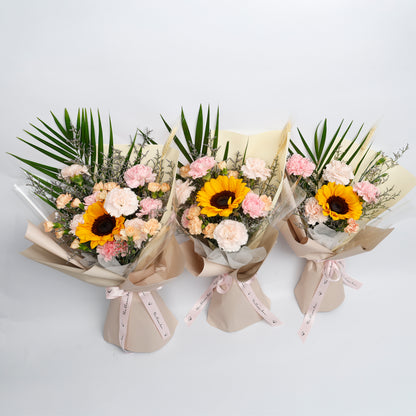 Three flower bouquets with sunflowers and pink flowers on a light gray background