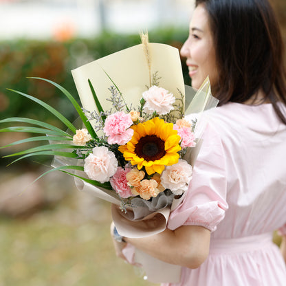 Woman holding a bouquet of flowers with a blurred background