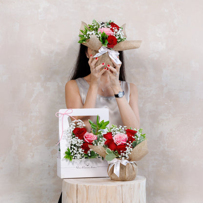 Woman holding a bouquet of flowers with a plain background