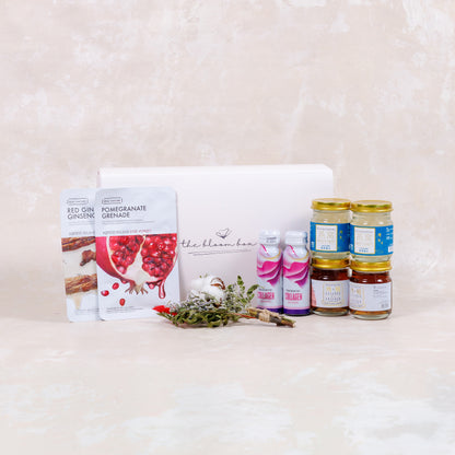 Assorted health and wellness products including jars, bottles, and a box on a light background