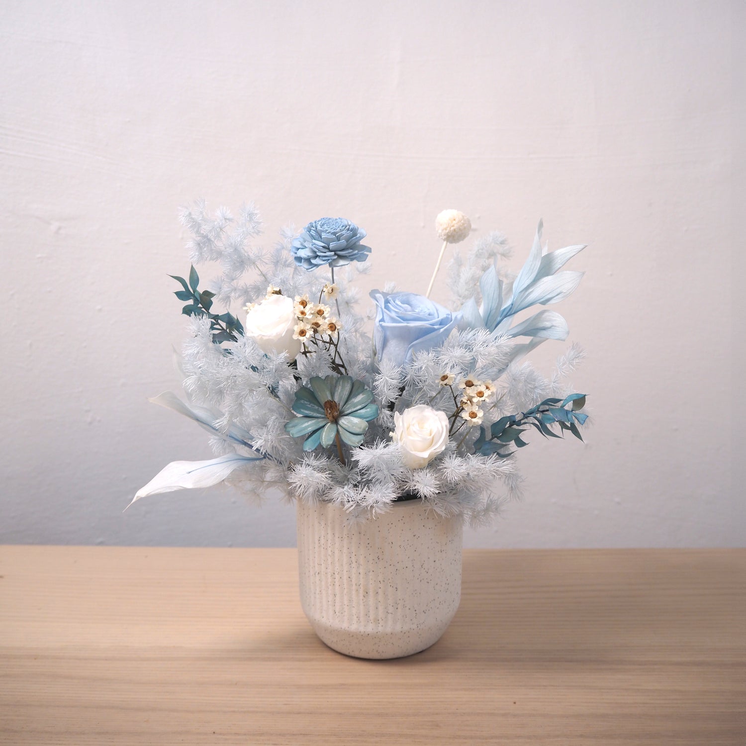 blue flowers arrangement on table 